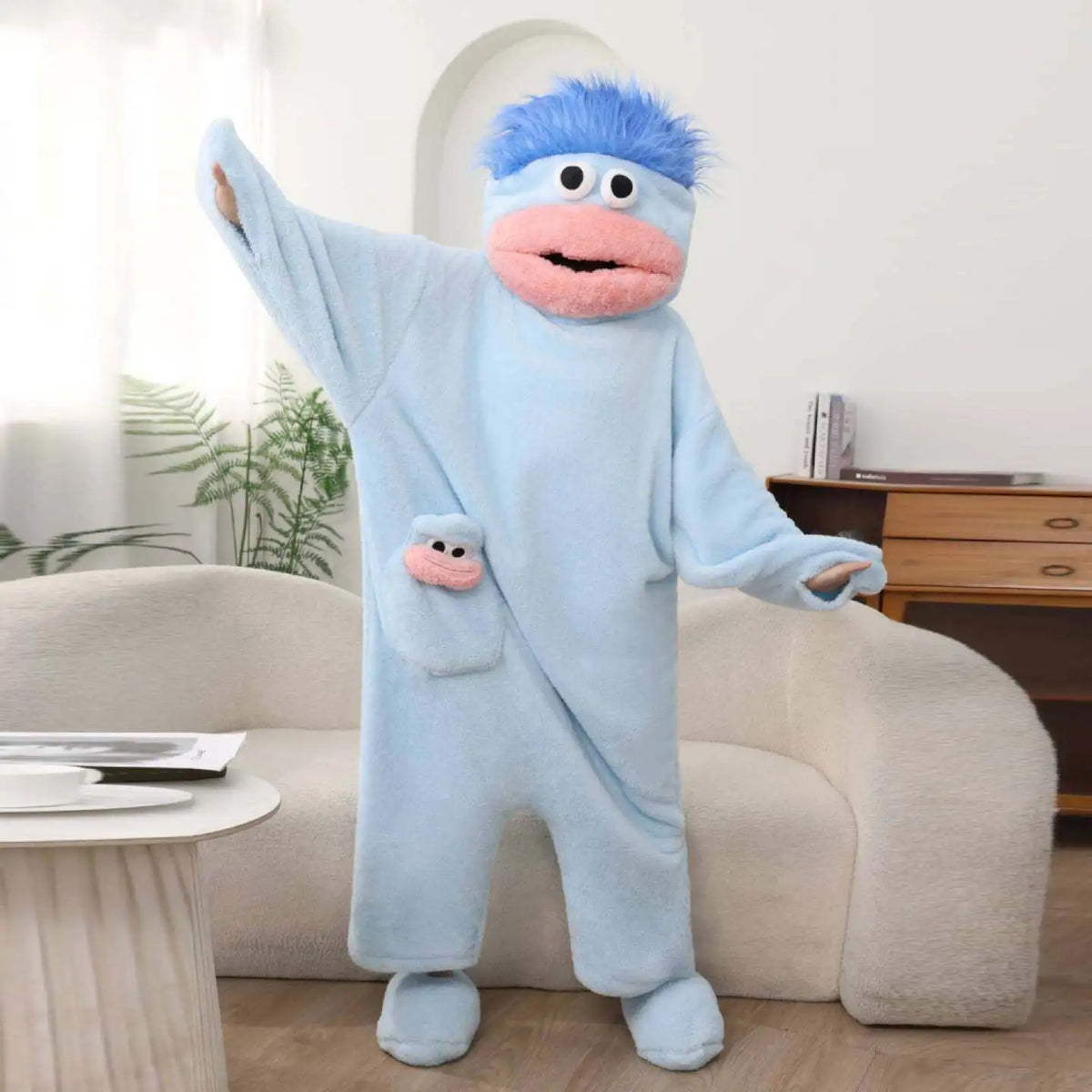 Light blue Big Mouth Monster onesie with blue hair and mini face pocket