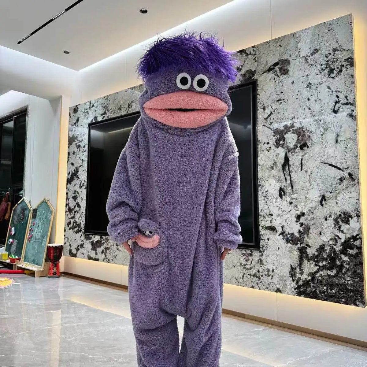 Purple Big Mouth Monster onesie with purple hair and pink mouth