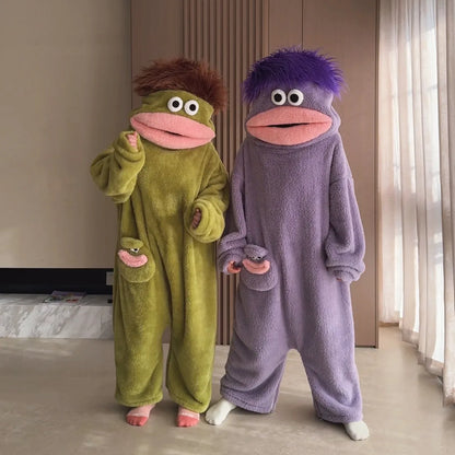 Two people wearing sage green and purple Big Mouth Monster onesies together